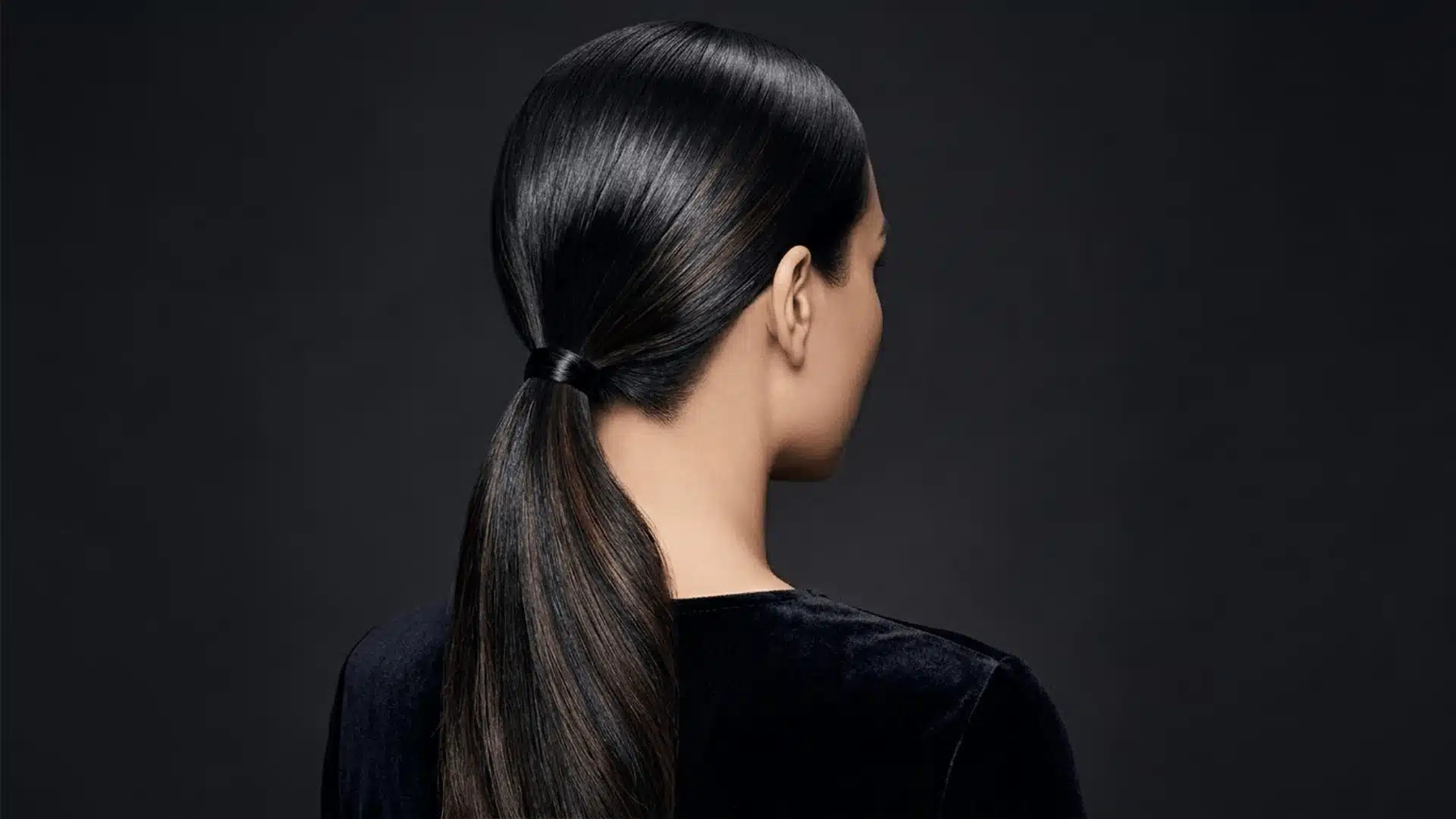 black hair ponytail with subtle espresso lowlights adding soft natural dimension