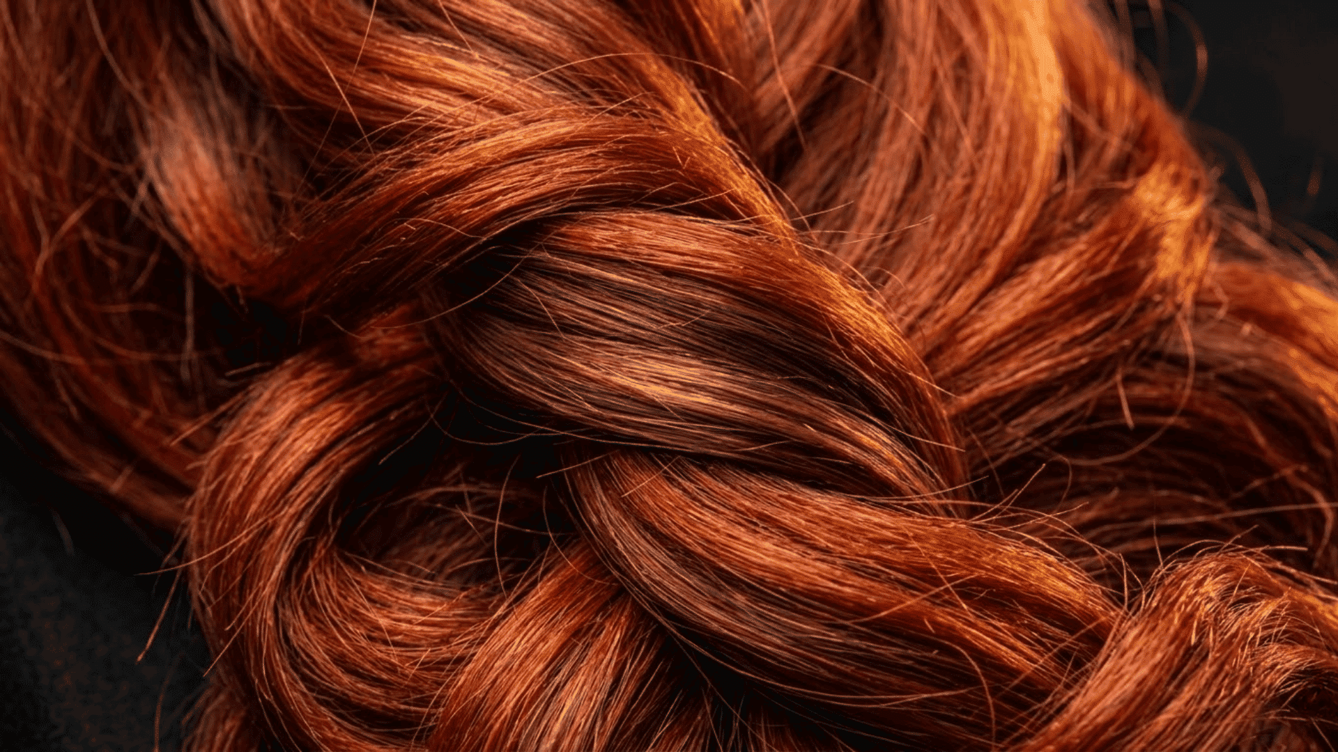 red hair with auburn and cinnamon lowlights showing vibrant warm dimension