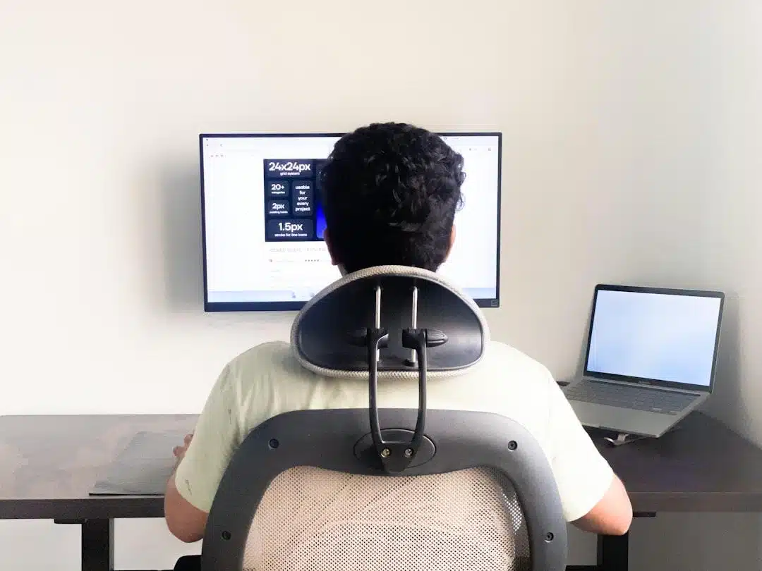 A person studying on a laptop at a tidy desk