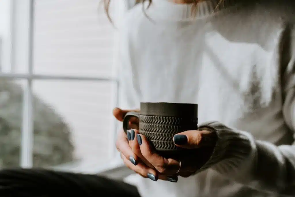 A woman relaxing at home with a warm drink