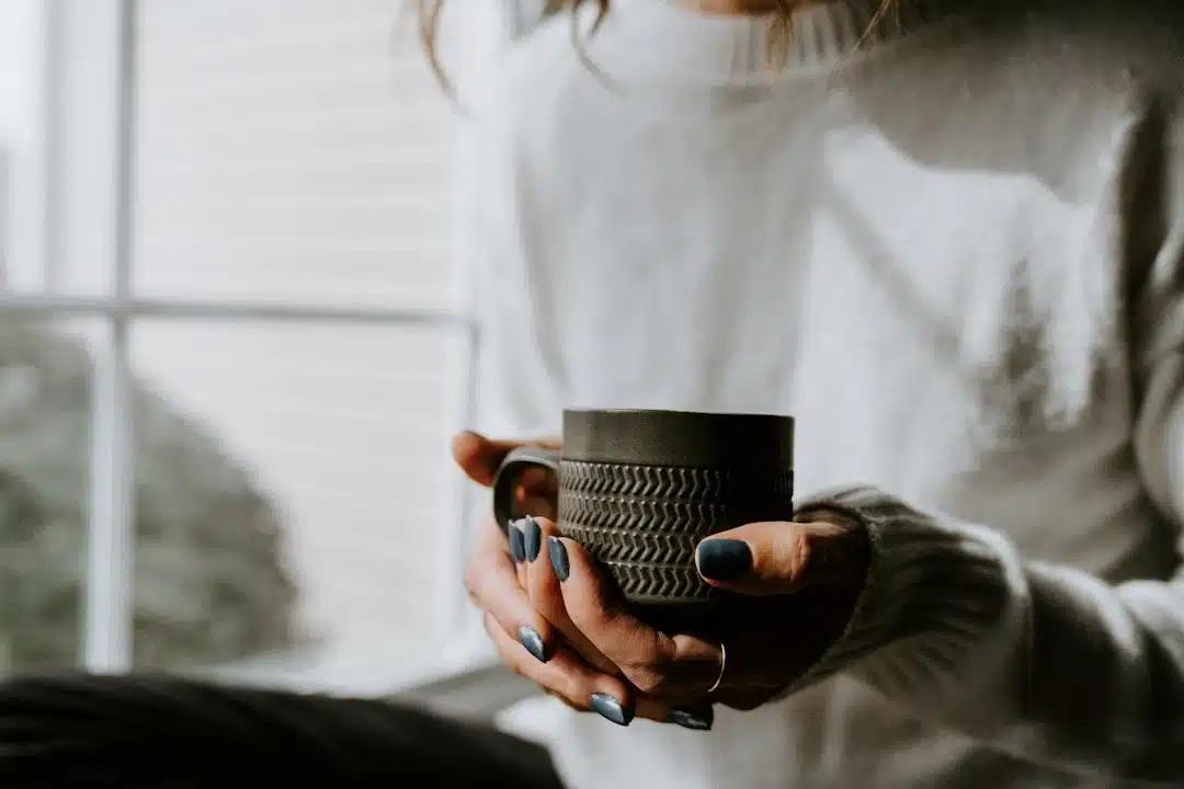 A woman relaxing at home with a warm drink