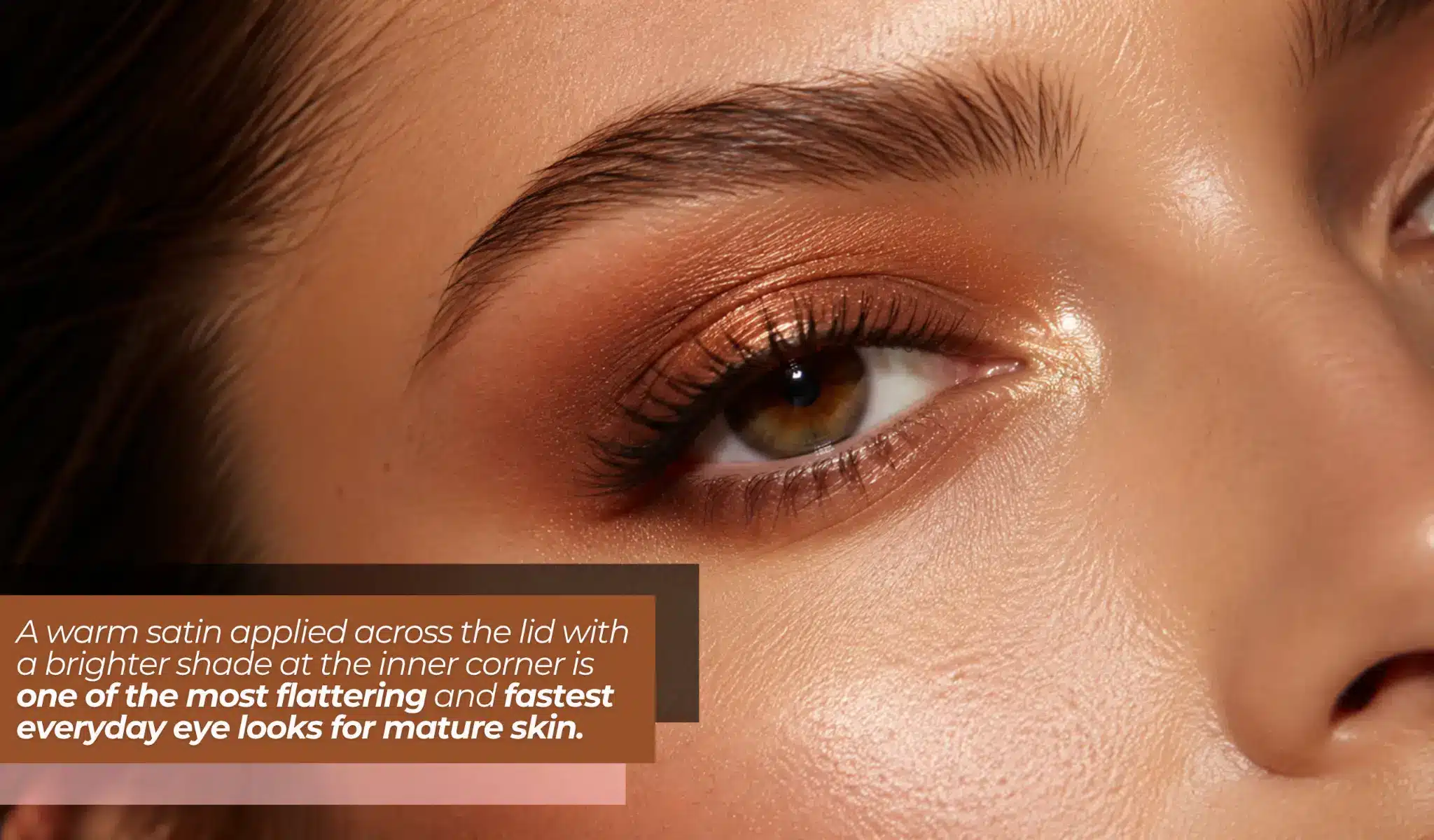 Close-up of an eye with warm copper eyeshadow and defined eyebrow
