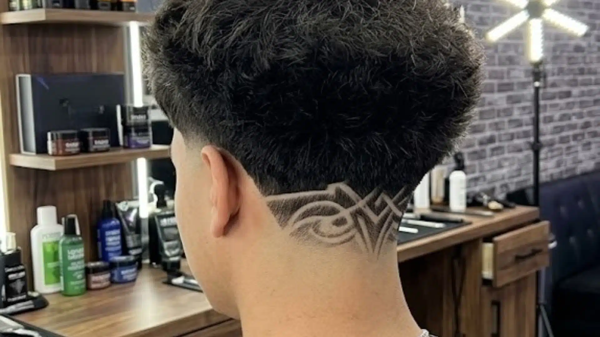 Back view of a textured Edgar haircut featuring a shaved line design on the neck