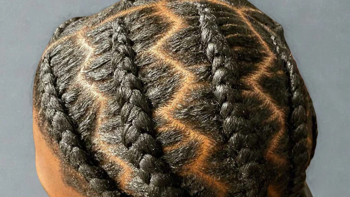 Close-up of hair featuring braids arranged in a zigzag pattern, highlighting creativity in hairstyling.