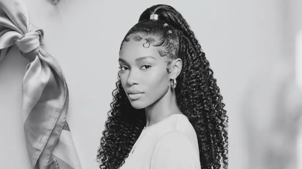 Black woman with sleek half-up ponytail, swooped edges, and long curly hair.