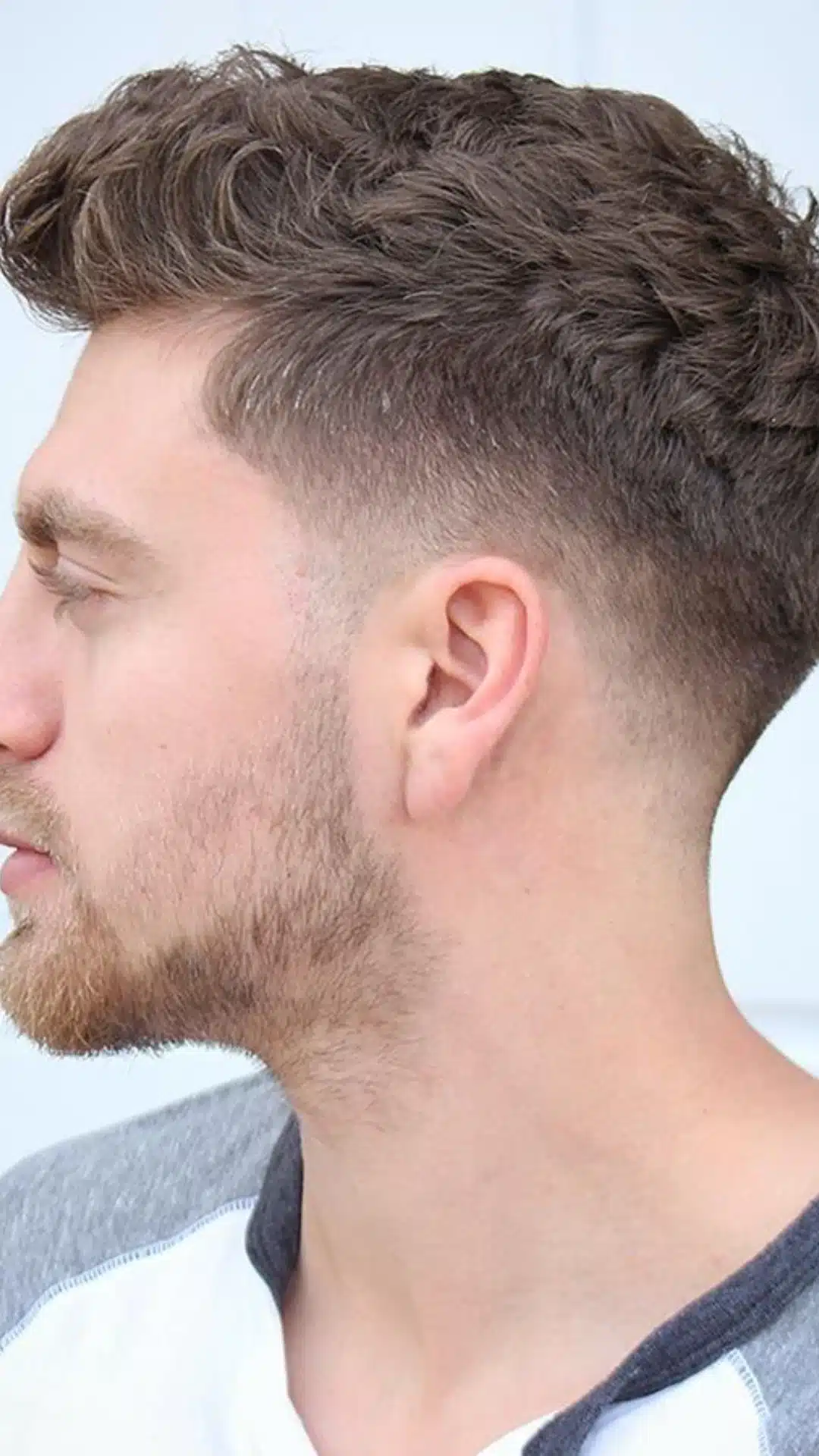 Ivy League haircut with textured top and taper fade