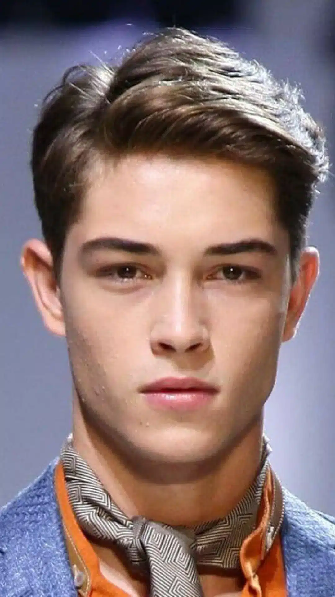 Man with a classic side part hairstyle that complements square face features with a timeless polished style