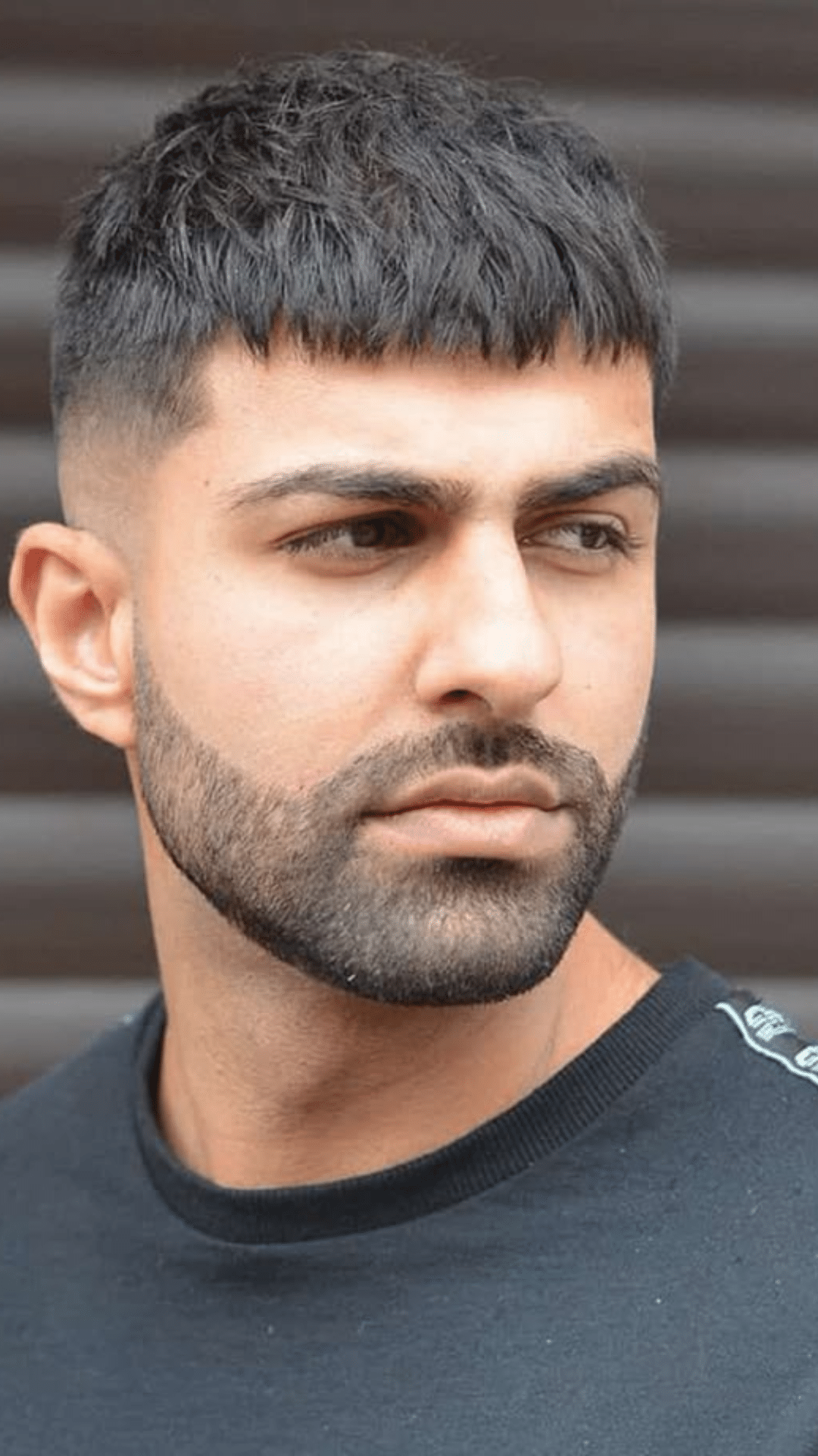 Man with a French crop haircut that gives square face shapes a sharp balanced appearance