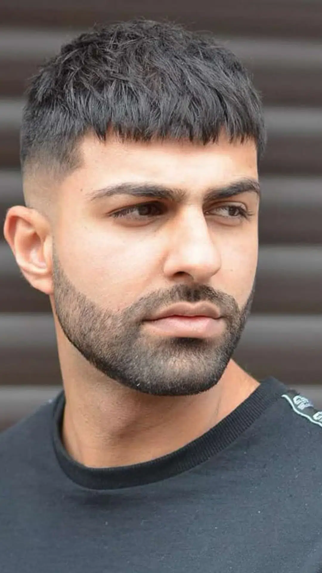 Man with a French crop haircut that gives square face shapes a sharp balanced appearance