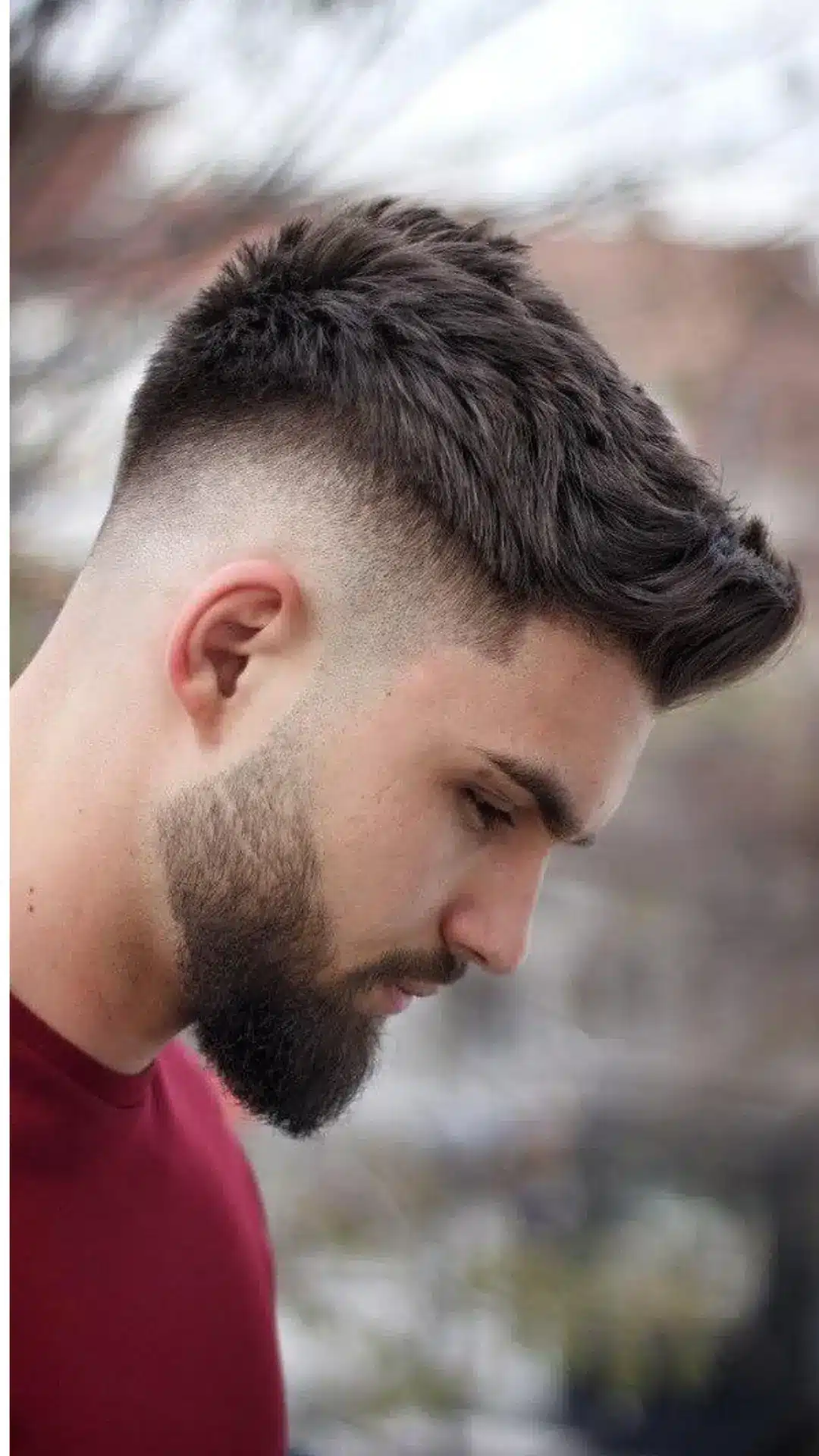 Man with a modern undercut hairstyle that enhances a square jawline with bold contrast