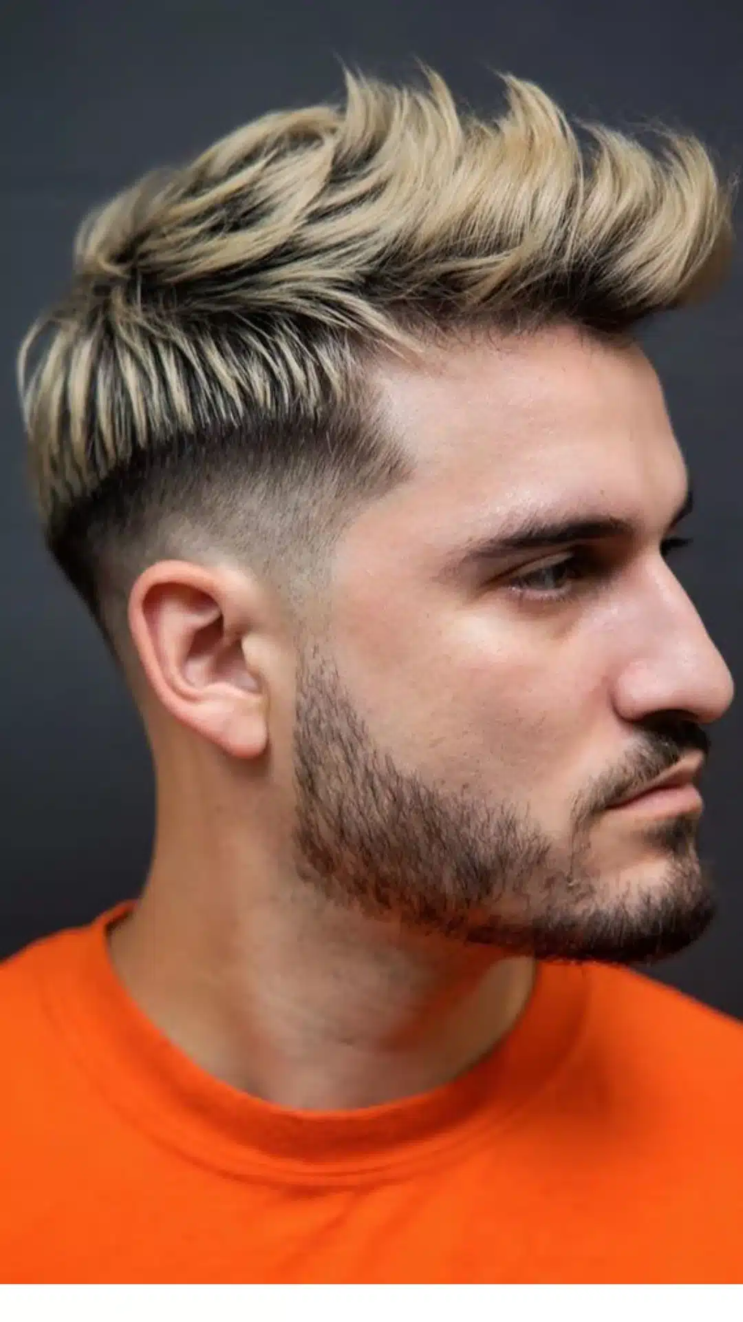 Man with a textured quiff hairstyle and high fade that adds volume and suits square face shapes