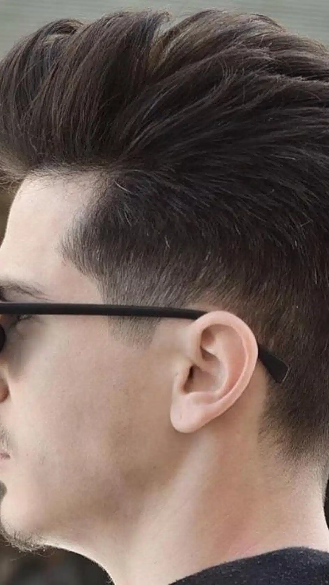 Pompadour haircut with a high fade and side profile