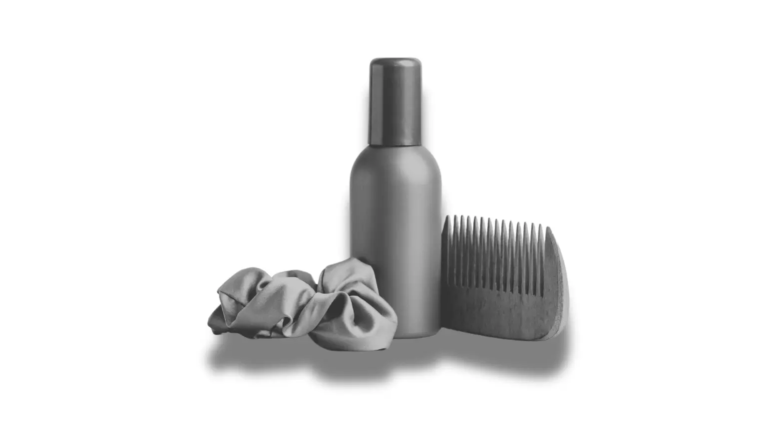 Sea salt spray bottle with a wooden comb and hair scrunchie, arranged together on a plain white background.